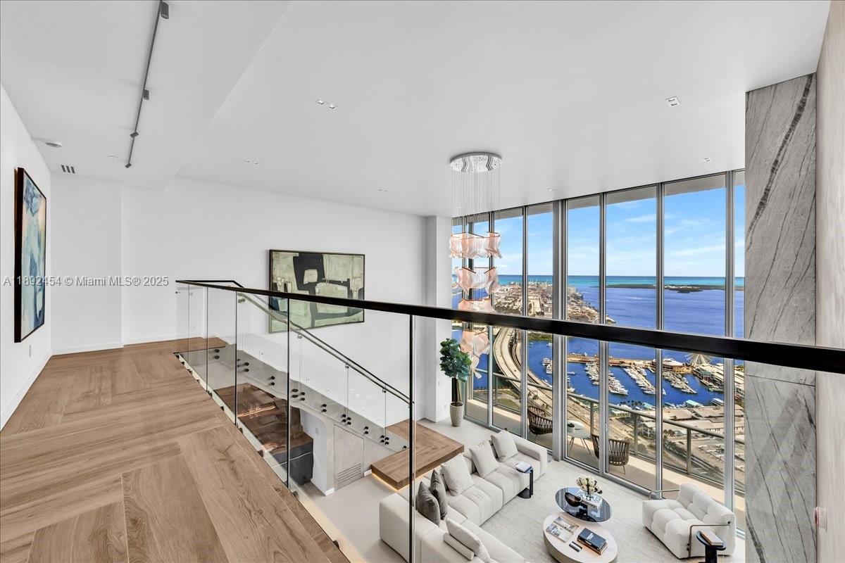 888 Biscayne Boulevard, Unit PH5704 Miami, FL 33132 - Photo 35 of 62 a view of a hallway with wooden floor and windows