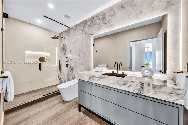 a spacious bedroom with a bed and a flat screen tv