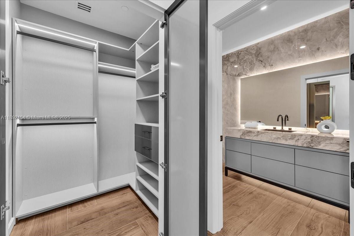 888 Biscayne Boulevard, Unit PH5704 Miami, FL 33132 - Photo 40 of 62 a bathroom with a sink and mirror