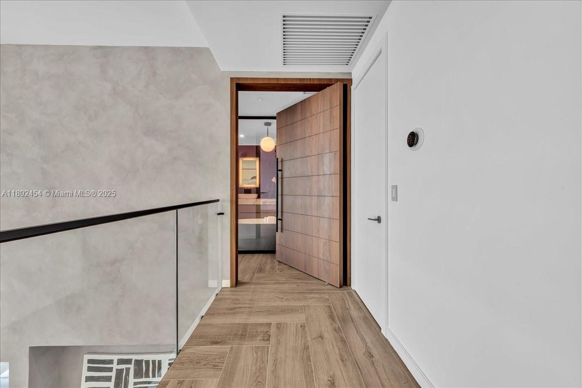 888 Biscayne Boulevard, Unit PH5704 Miami, FL 33132 - Photo 41 of 62 a view of a hallway with wooden floor and entryway