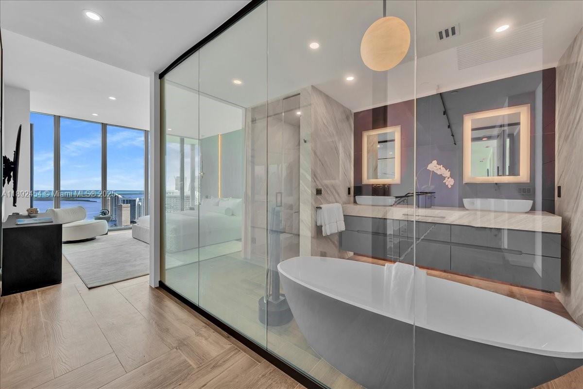 888 Biscayne Boulevard, Unit PH5704 Miami, FL 33132 - Photo 42 of 62 a large spacious bathroom with a large tub shower and sink