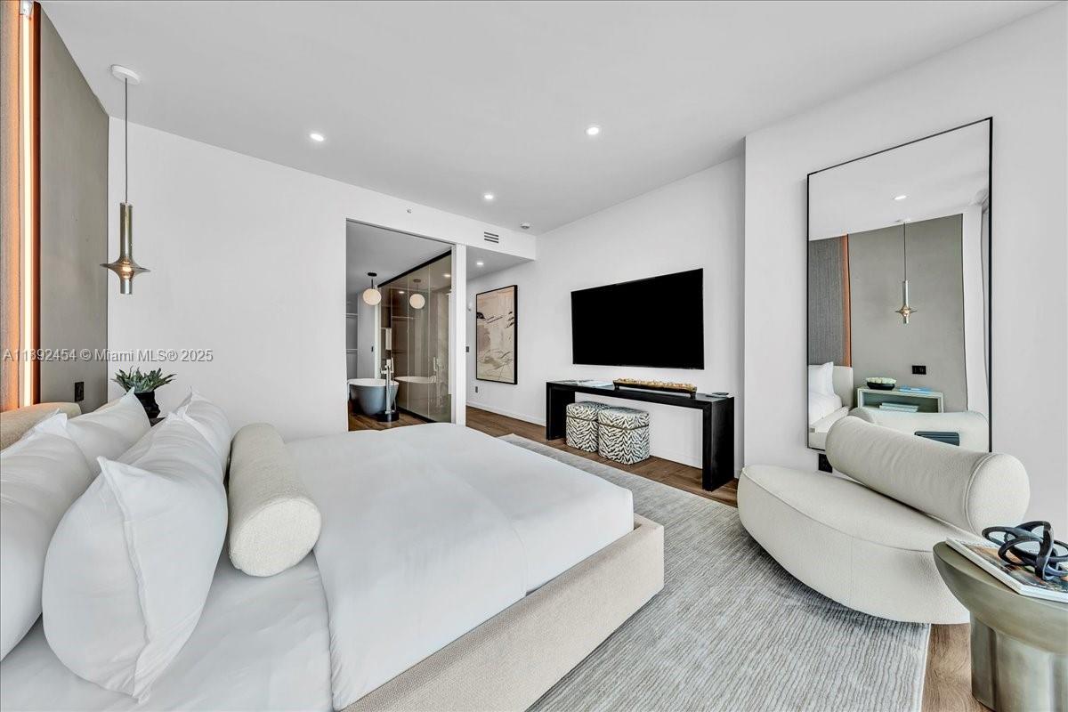 888 Biscayne Boulevard, Unit PH5704 Miami, FL 33132 - Photo 45 of 62 a living room with furniture and a flat screen tv