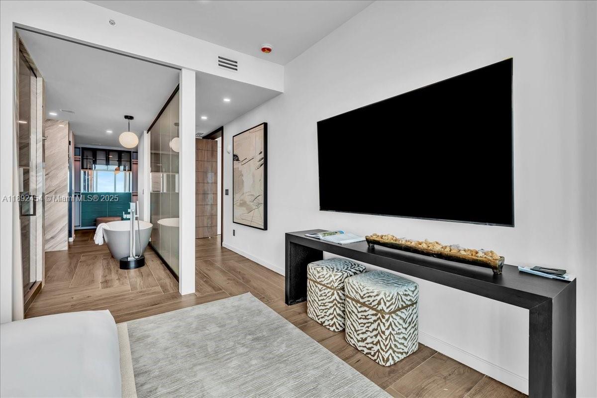 888 Biscayne Boulevard, Unit PH5704 Miami, FL 33132 - Photo 46 of 62 a living room with furniture and a flat screen tv