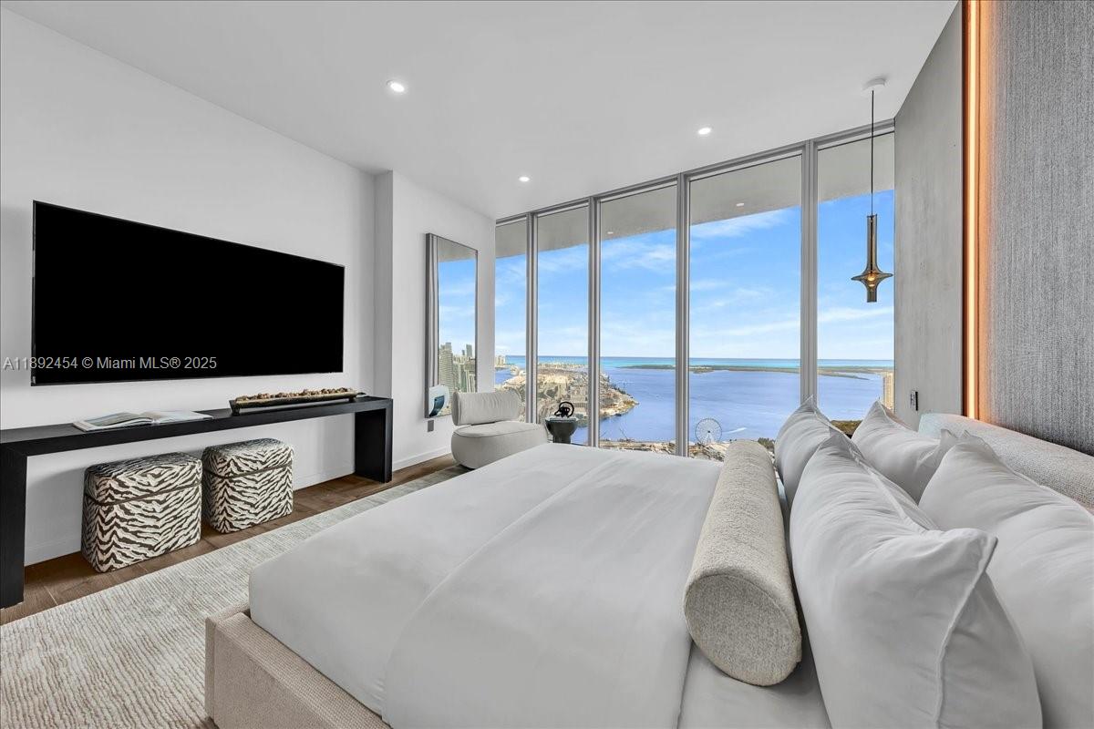 888 Biscayne Boulevard, Unit PH5704 Miami, FL 33132 - Photo 48 of 62 a living room with furniture and a flat screen tv