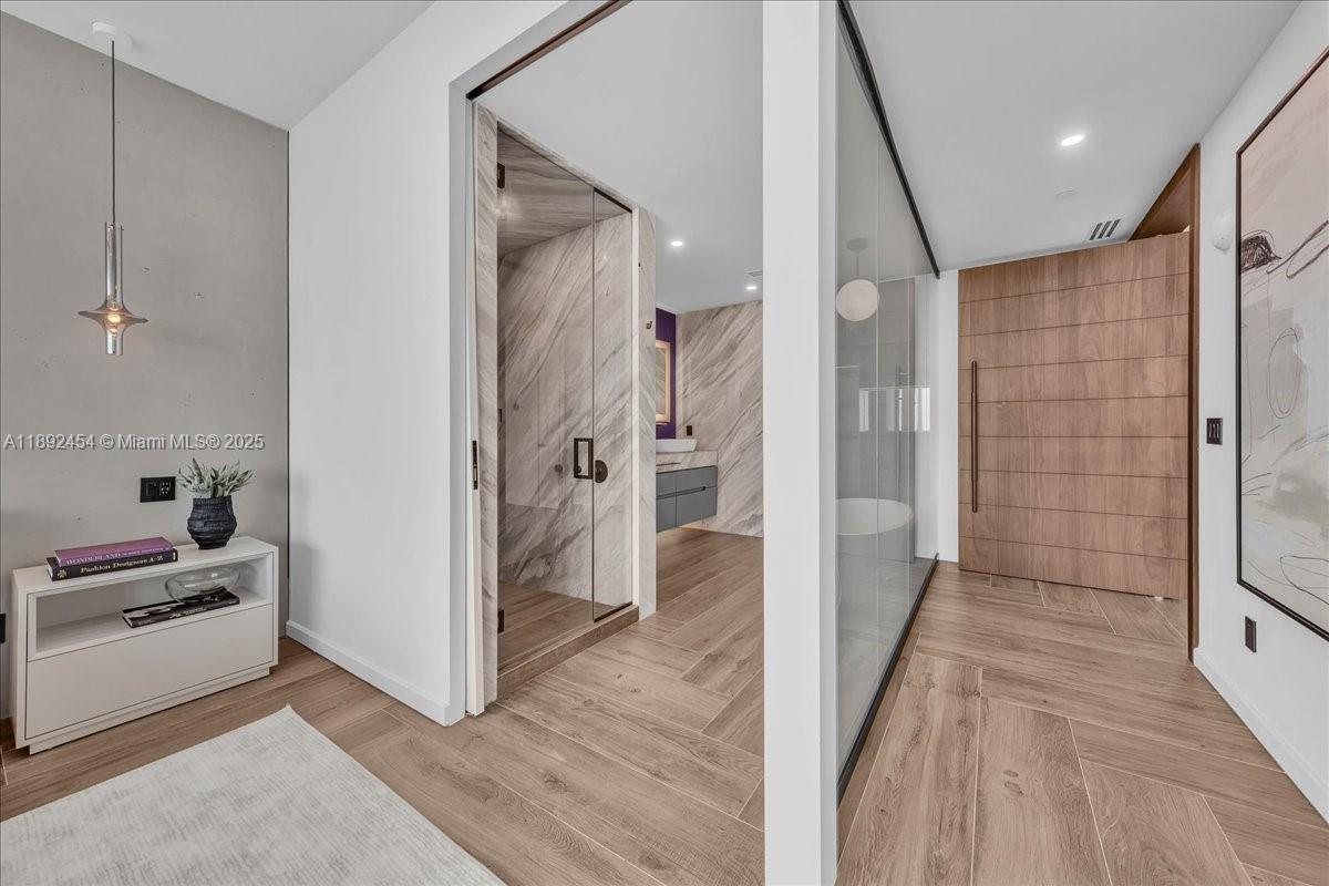 888 Biscayne Boulevard, Unit PH5704 Miami, FL 33132 - Photo 50 of 62 a view of a hallway with wooden floor and staircase