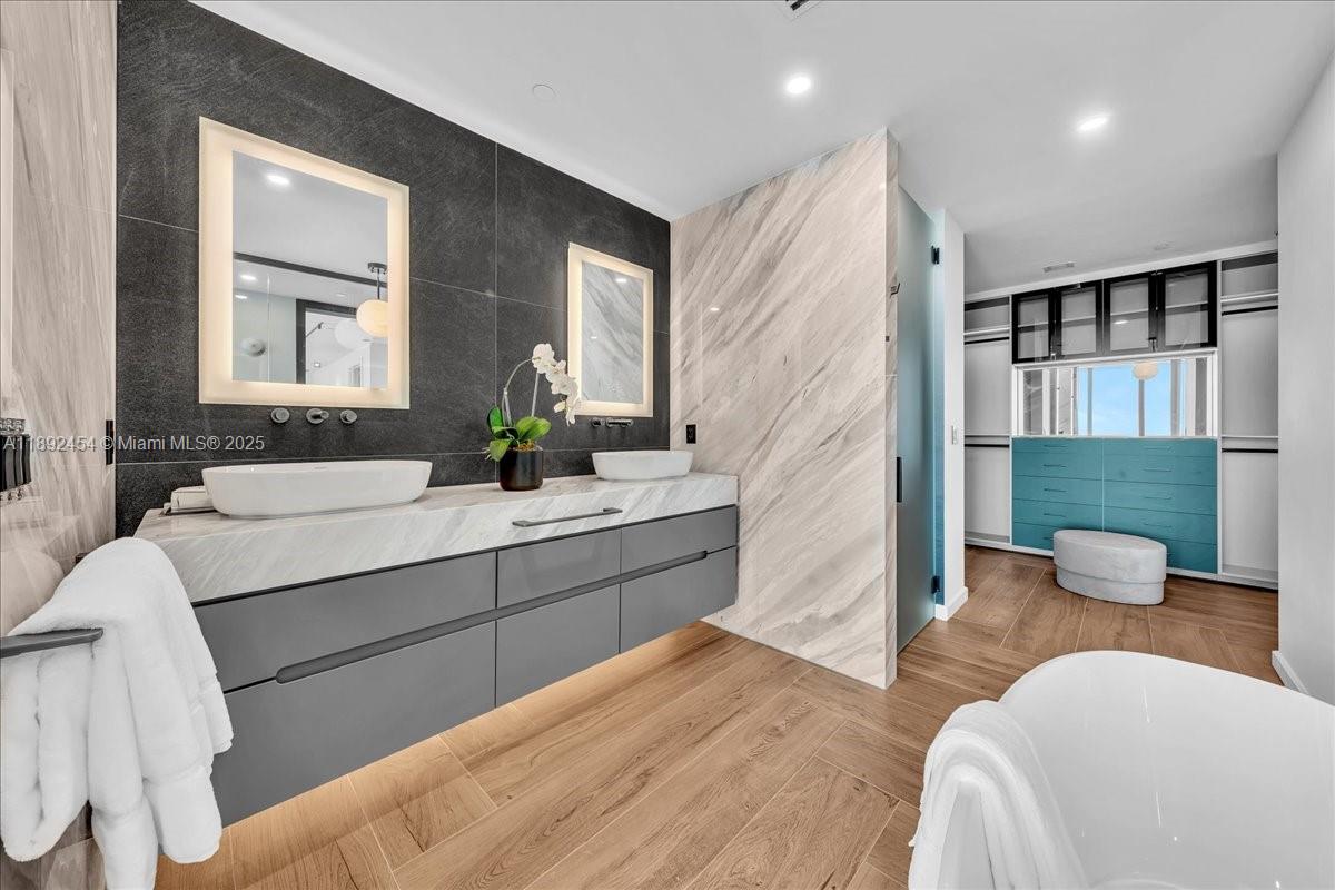 888 Biscayne Boulevard, Unit PH5704 Miami, FL 33132 - Photo 52 of 62 a bathroom with a sink and a large mirror