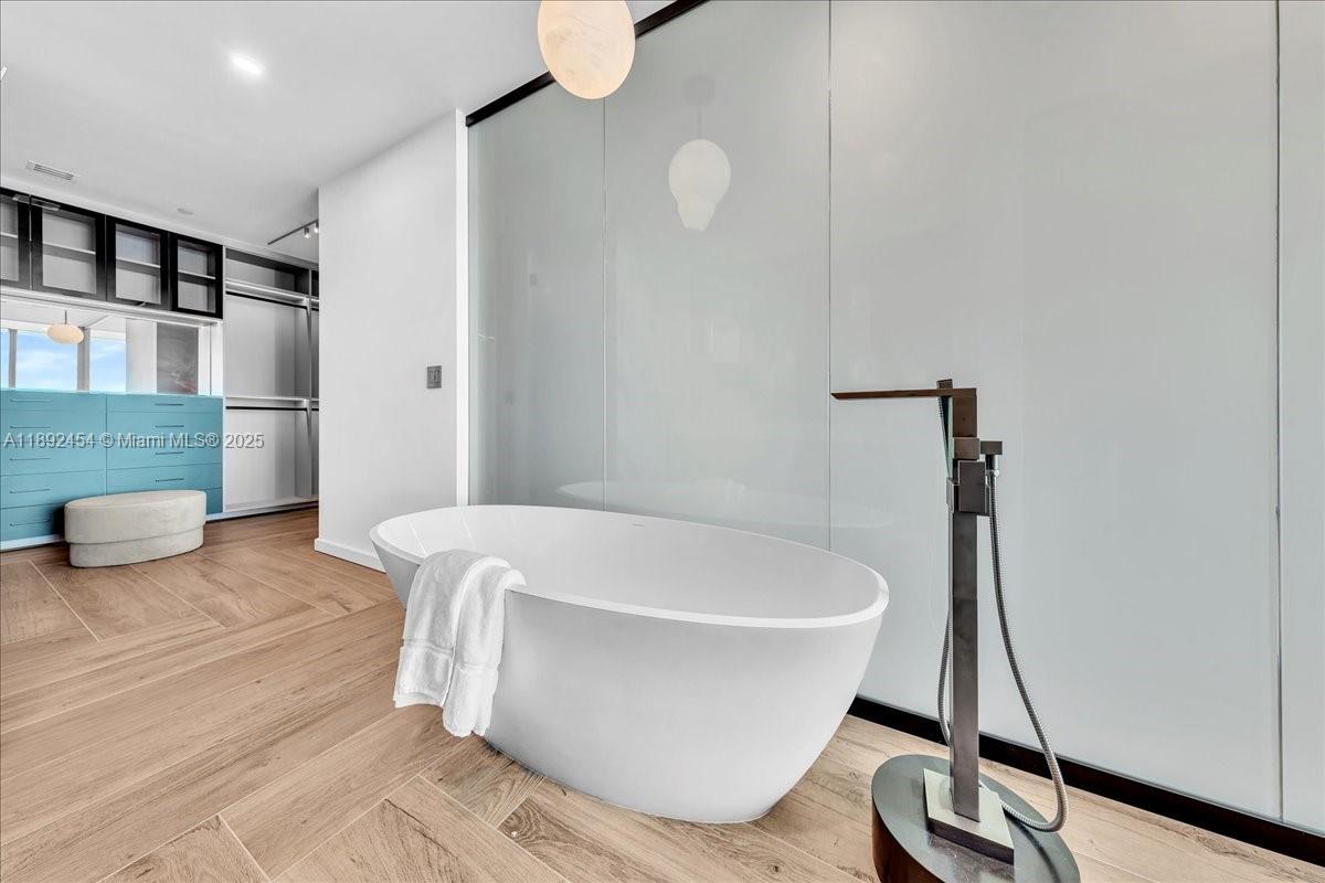 888 Biscayne Boulevard, Unit PH5704 Miami, FL 33132 - Photo 55 of 62 a white bath tub sitting in a bathroom