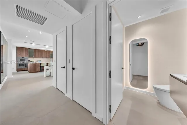 a kitchen with stainless steel appliances granite countertop a sink and a large window