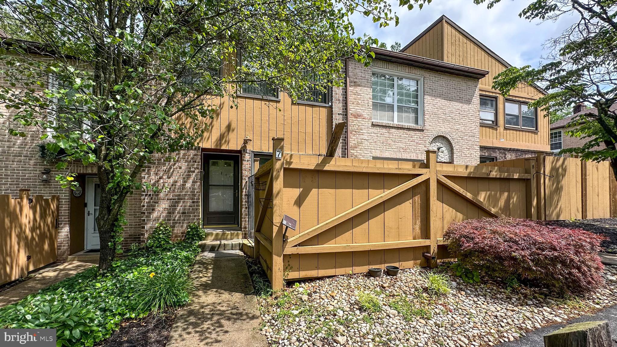 a view of a house with wooden fence