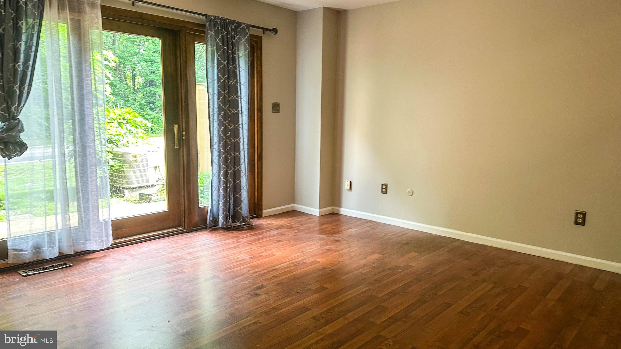 7 Pinehurst Court Reading, PA 19607 - Photo 6 of 11 an empty room with wooden floor and windows