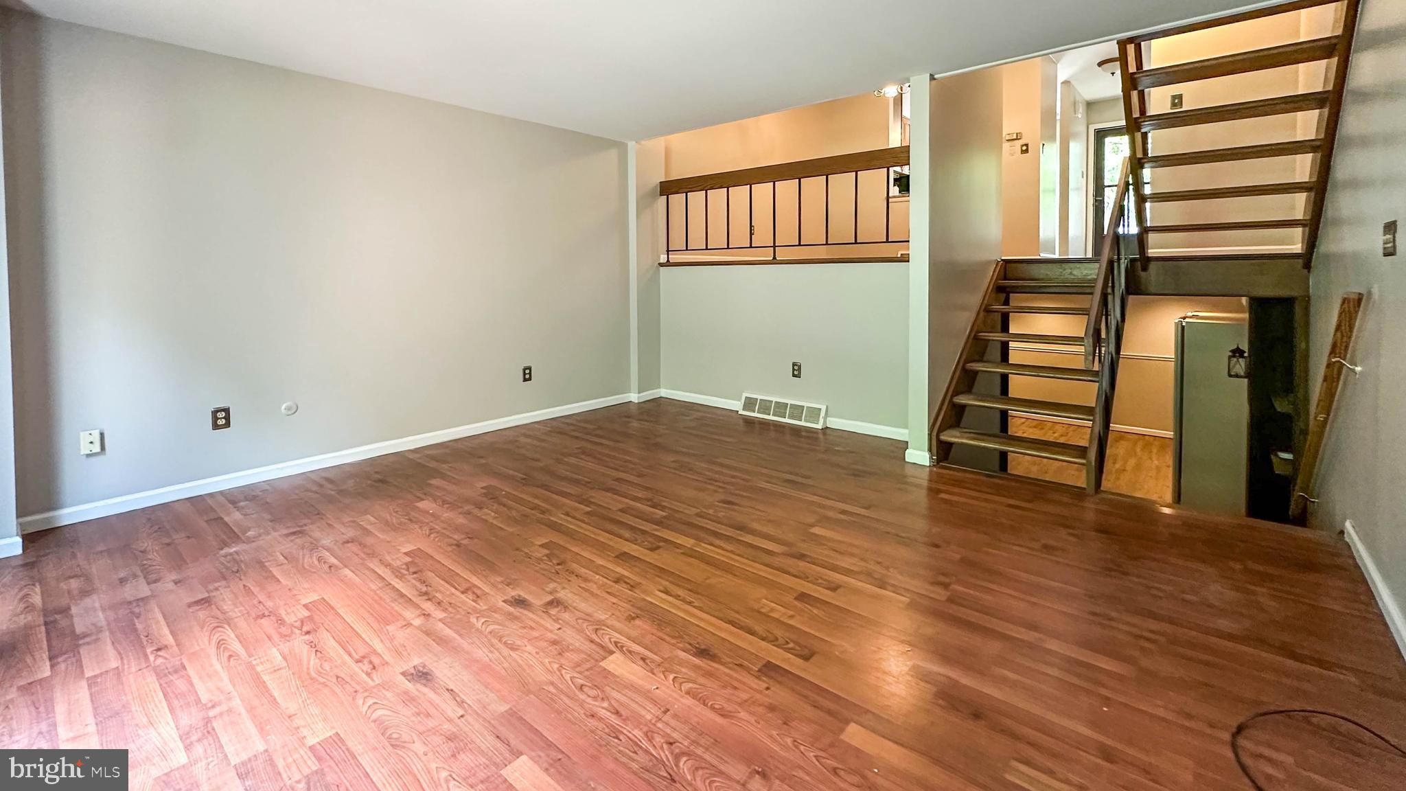 7 Pinehurst Court Reading, PA 19607 - Photo 7 of 11 a view of an empty room with wooden floor and stairs