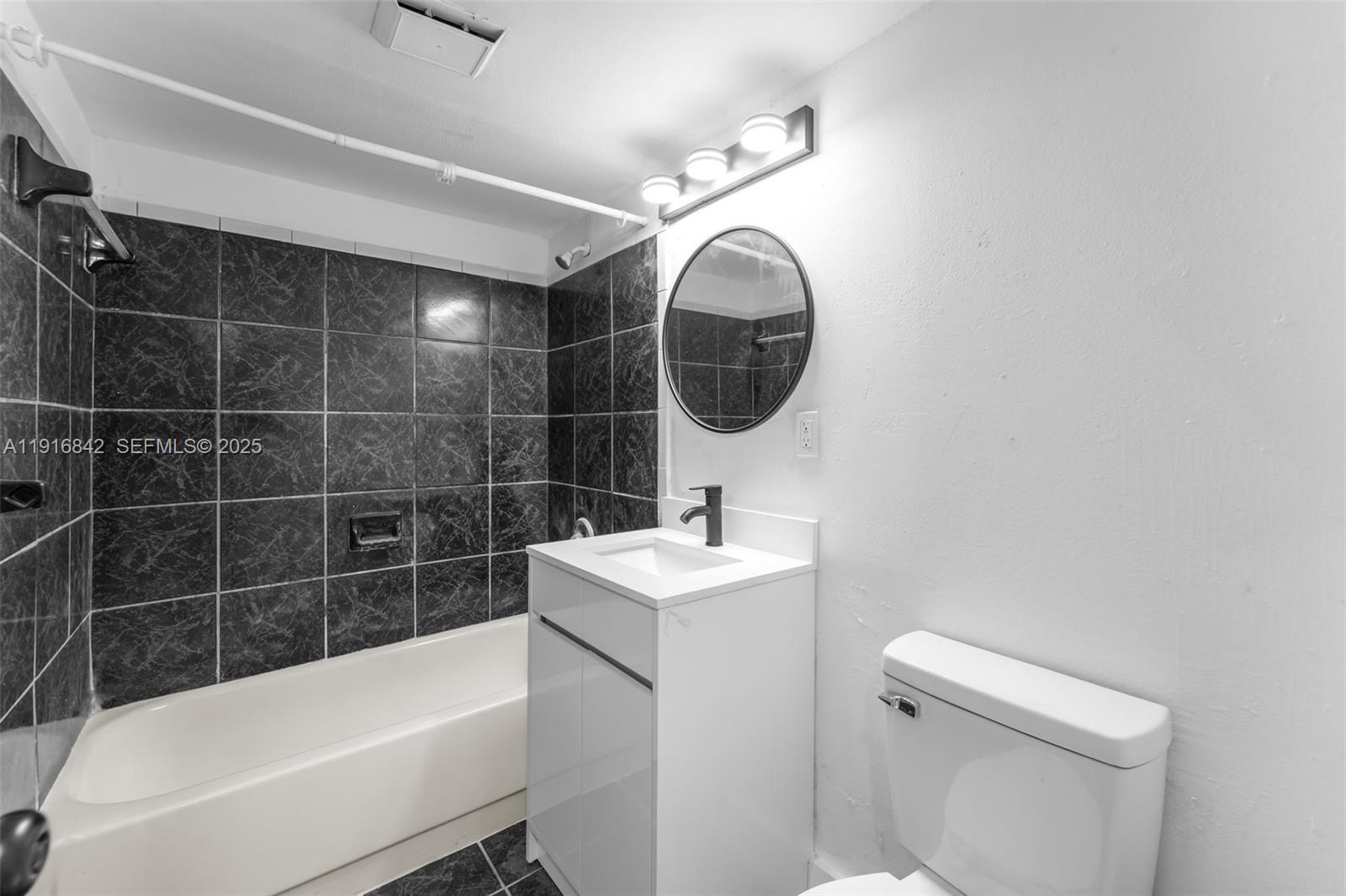 6011 Southwest 69th Street, Unit 72 South Miami, FL 33143 - Photo 11 of 22 a bathroom with a sink a toilet and bathtub