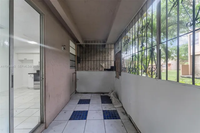 a view of an empty room and wooden floor