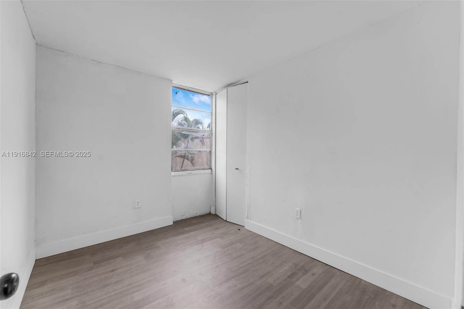 6011 Southwest 69th Street, Unit 72 South Miami, FL 33143 - Photo 17 of 22 a view of an empty room and wooden floor