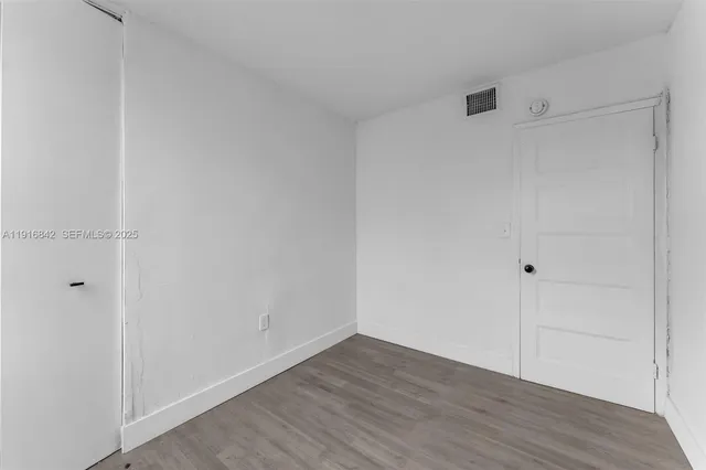 an aerial view of a house with a garden and lake view