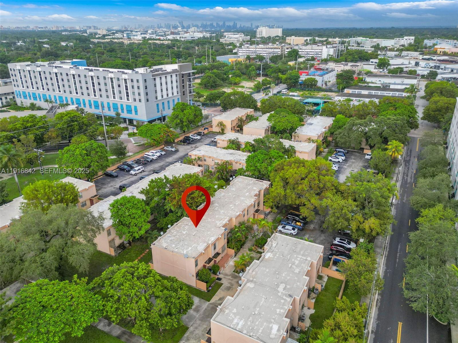 6011 Southwest 69th Street, Unit 72 South Miami, FL 33143 - Photo 20 of 22 an aerial view of a house with a garden and lake view