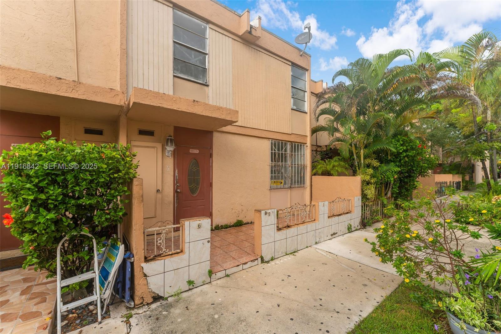 6011 Southwest 69th Street, Unit 72 South Miami, FL 33143 - Photo 2 of 22 a view of a house with backyard and sitting area