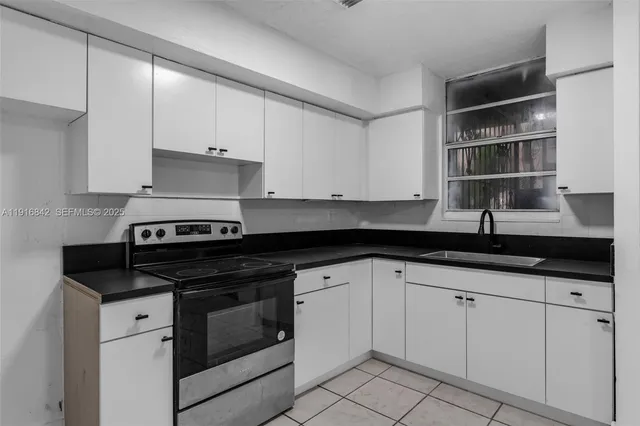 a view of an empty room with a kitchen