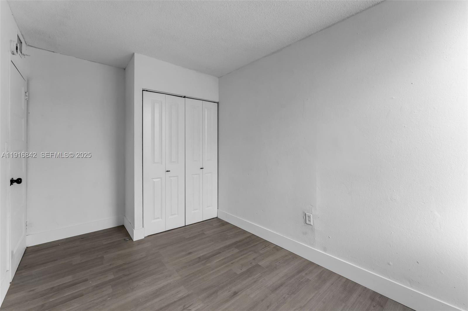 6011 Southwest 69th Street, Unit 72 South Miami, FL 33143 - Photo 10 of 22 a view of an empty room with wooden floor
