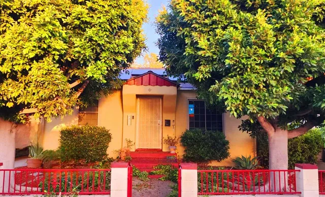 front view of a house with a tree