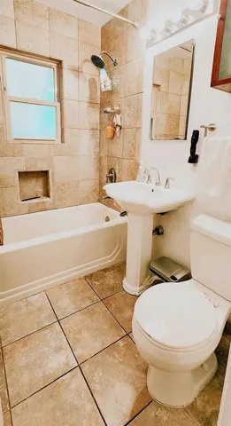 a white toilet sitting next to a bathroom sink