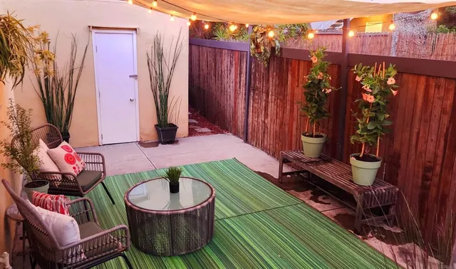 a backyard of a house with barbeque oven table and chairs