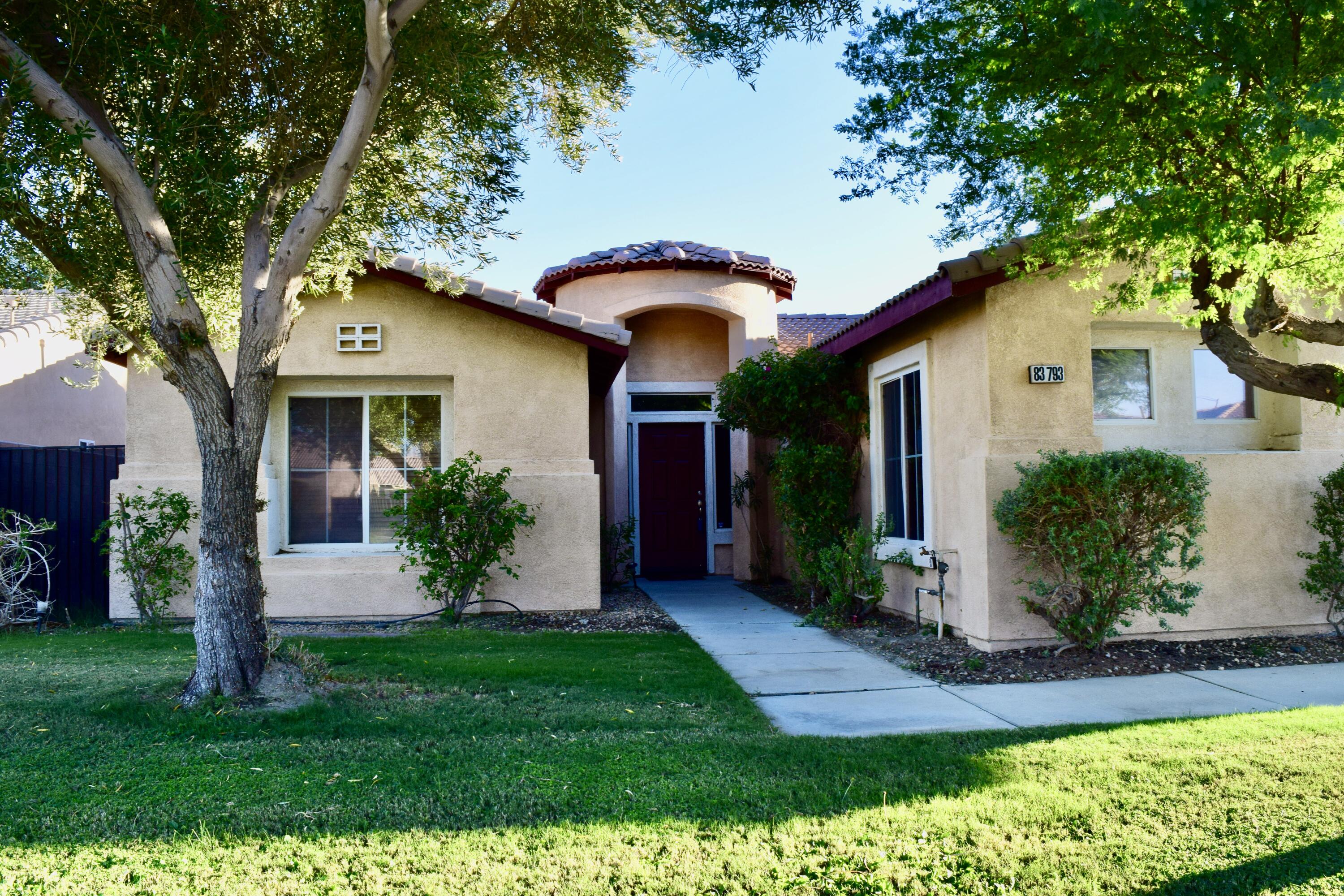 83793 Pacifica Sur Indio, CA 92203 - Photo 1 of 22 a front view of a house with a yard