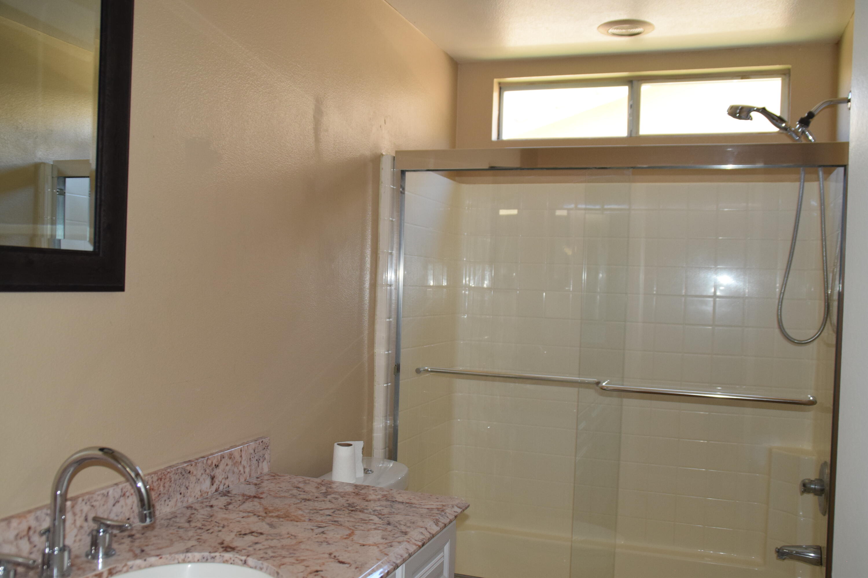83793 Pacifica Sur Indio, CA 92203 - Photo 16 of 22 a bathroom with a granite countertop sink and a mirror