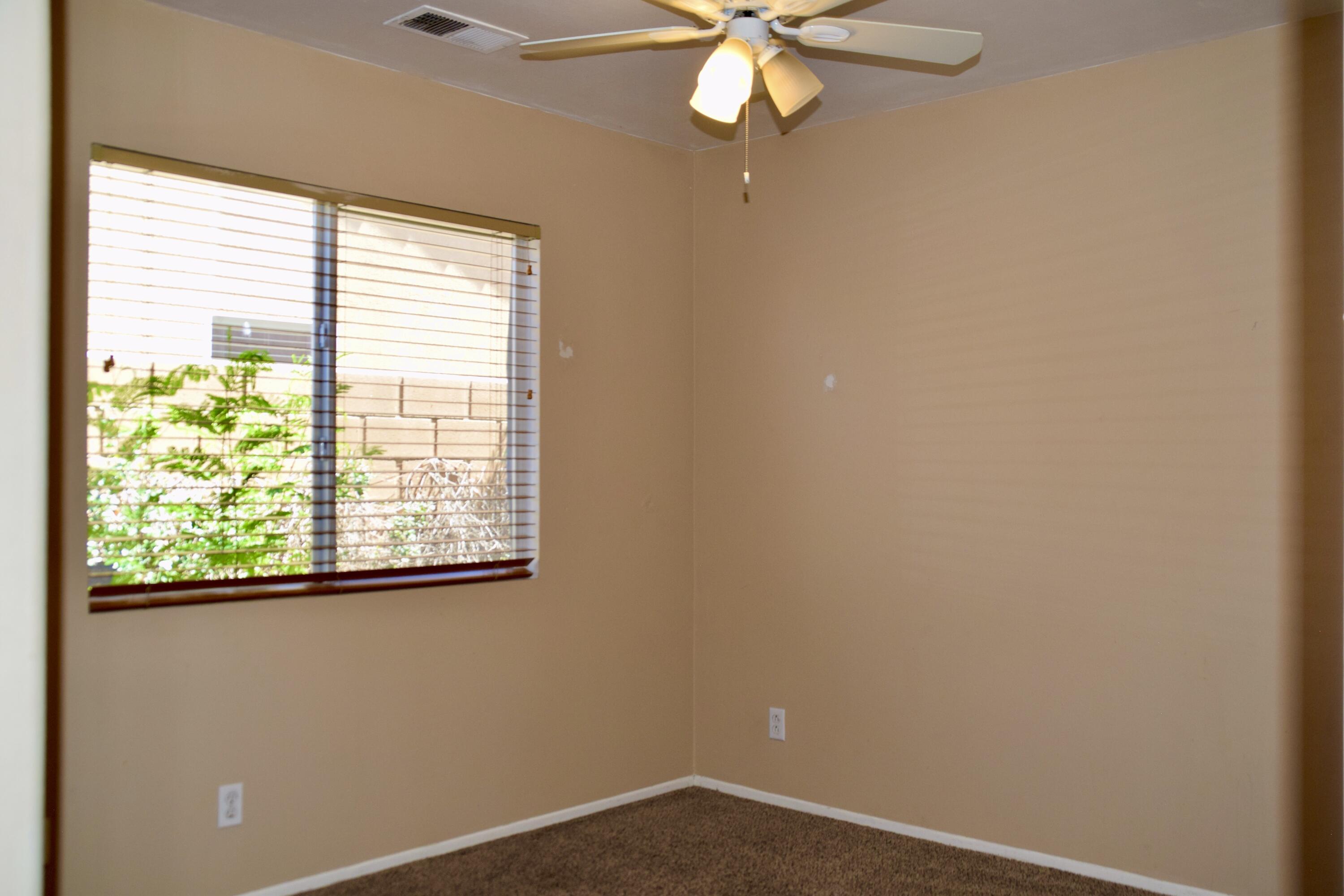 83793 Pacifica Sur Indio, CA 92203 - Photo 17 of 22 an empty room with a window and a fan
