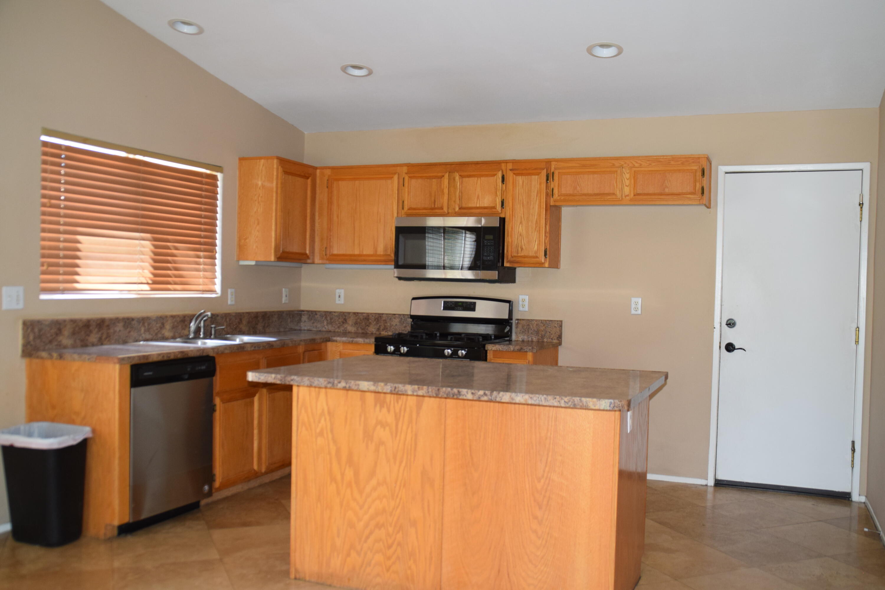 83793 Pacifica Sur Indio, CA 92203 - Photo 8 of 22 a kitchen with granite countertop a sink stove and refrigerator