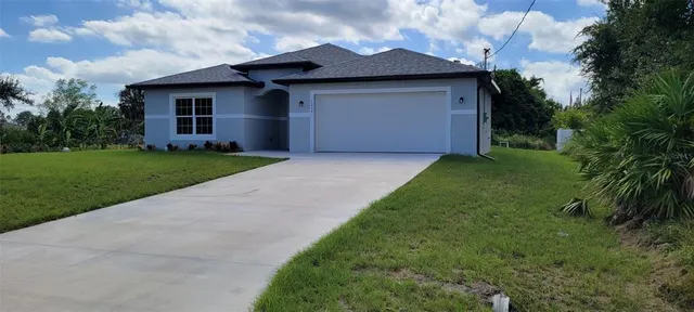 a front view of house with yard and green space