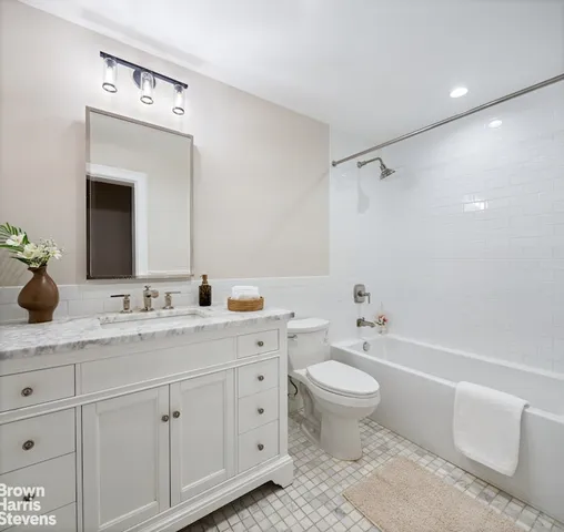 a view of kitchen with stainless steel appliances wooden floor and living room