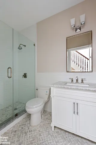 a bathroom with a granite countertop sink mirror and toilet