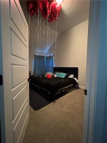 a bed sitting in a bedroom next to a window