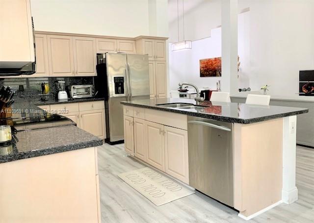 8181 Horseshoe Bay Road Boynton Beach, FL 33472 - Photo 11 of 41 a kitchen with stainless steel appliances granite countertop a sink stove and refrigerator