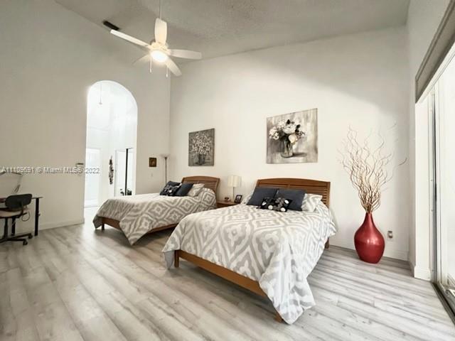 8181 Horseshoe Bay Road Boynton Beach, FL 33472 - Photo 13 of 41 a bedroom with two beds and a chandelier