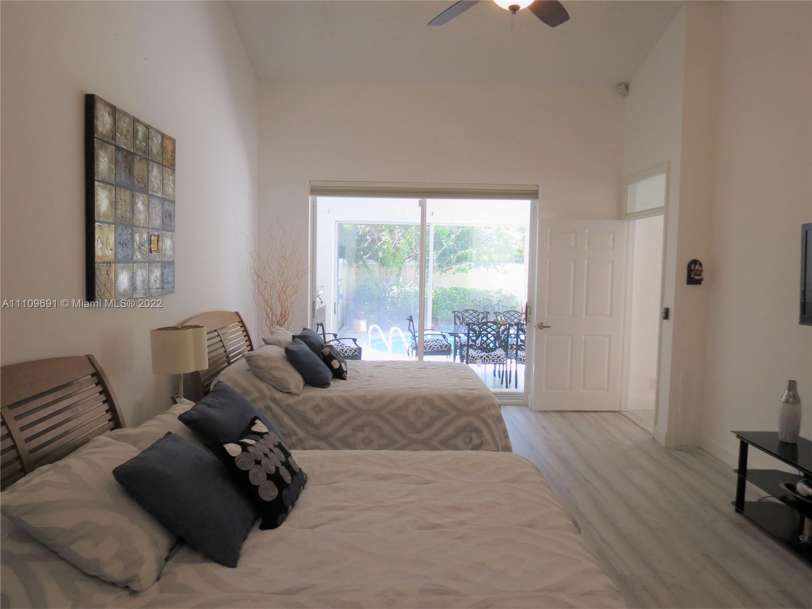 8181 Horseshoe Bay Road Boynton Beach, FL 33472 - Photo 17 of 41 a bed room with a bed and a couch