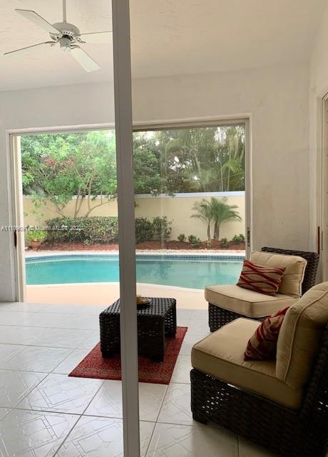 8181 Horseshoe Bay Road Boynton Beach, FL 33472 - Photo 20 of 41 a living room with furniture and a floor to ceiling window