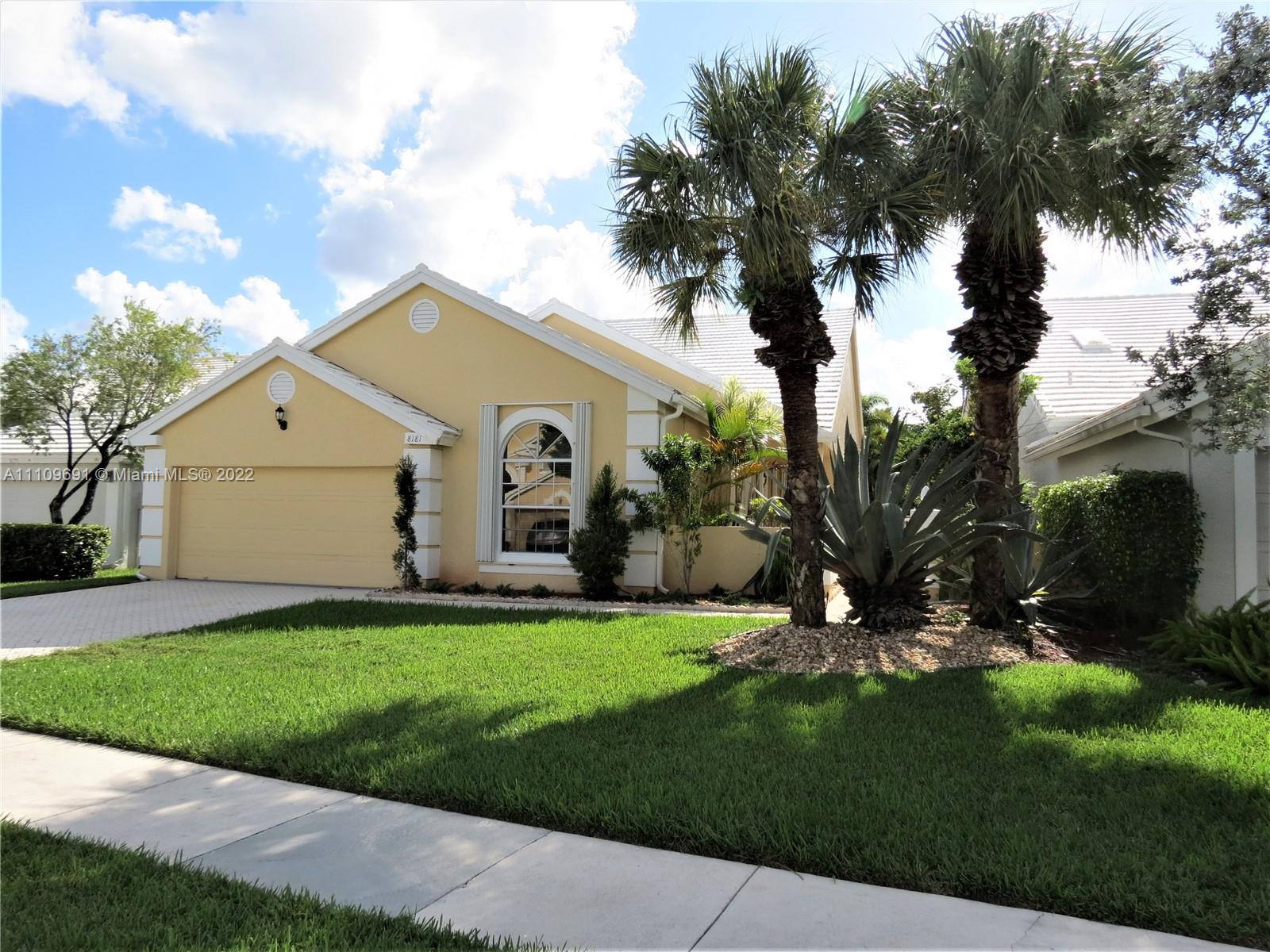 8181 Horseshoe Bay Road Boynton Beach, FL 33472 - Photo 2 of 41 a front view of a house with a yard and garage