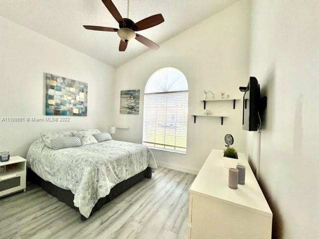 8181 Horseshoe Bay Road Boynton Beach, FL 33472 - Photo 21 of 41 a bedroom with a bed and a flat tv screen on dresser