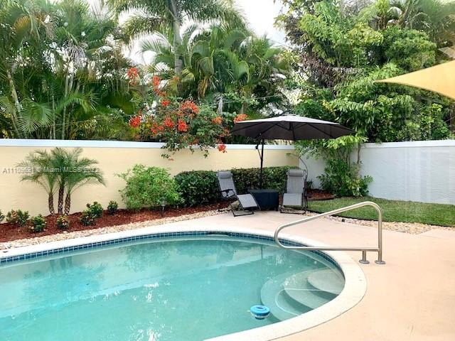 8181 Horseshoe Bay Road Boynton Beach, FL 33472 - Photo 26 of 41 a view of a swimming pool with a patio