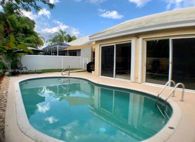 8181 Horseshoe Bay Road Boynton Beach, FL 33472 - Photo 27 of 41 a swimming pool with outdoor seating and yard