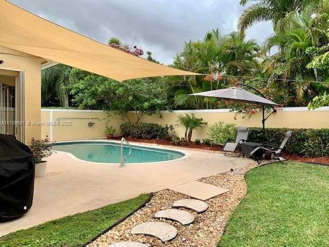 8181 Horseshoe Bay Road Boynton Beach, FL 33472 - Photo 29 of 41 a view of a backyard with plants and patio