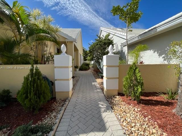 8181 Horseshoe Bay Road Boynton Beach, FL 33472 - Photo 3 of 41 a front view of a house with garden