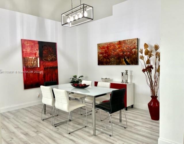 8181 Horseshoe Bay Road Boynton Beach, FL 33472 - Photo 7 of 41 a view of a dining room with furniture and wooden floor