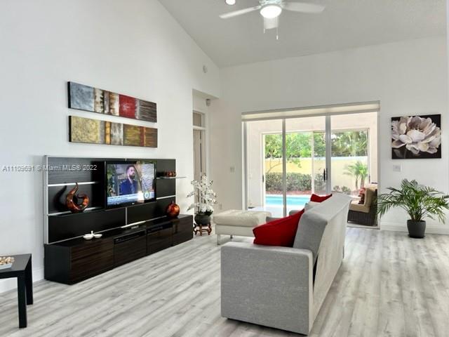 8181 Horseshoe Bay Road Boynton Beach, FL 33472 - Photo 8 of 41 a living room with furniture and a flat screen tv
