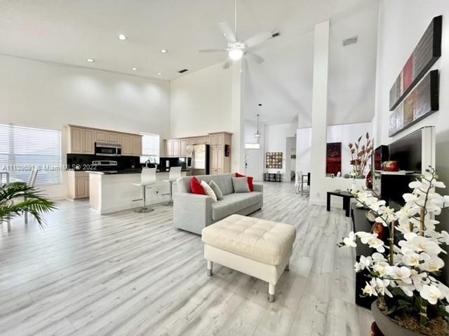 8181 Horseshoe Bay Road Boynton Beach, FL 33472 - Photo 9 of 41 a living room with furniture flat screen tv and wooden floor
