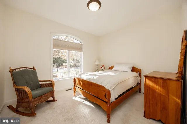 a spacious bedroom with a bed and a couch