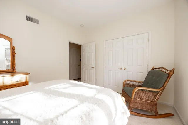 a bedroom with a bed and chair