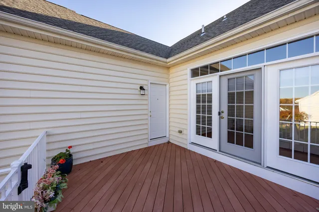 a view of a porch with wooden floor and potted plants